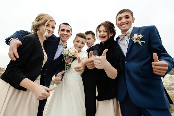 Bride and Groom with Happy Groomsmen and Bridesmaids Having Fun