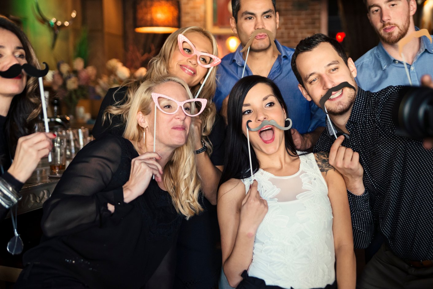 Friends and coworkers photo booth at a party in a bar.